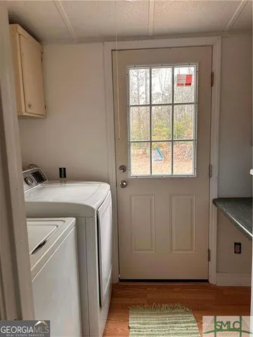 a view of storage and utility room with washer and dryer