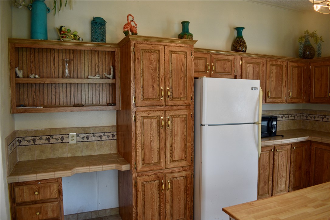 25051 Lake Shore Drive Mathis, TX 78368 - Photo 12 of 40 a white refrigerator freezer sitting in a kitchen