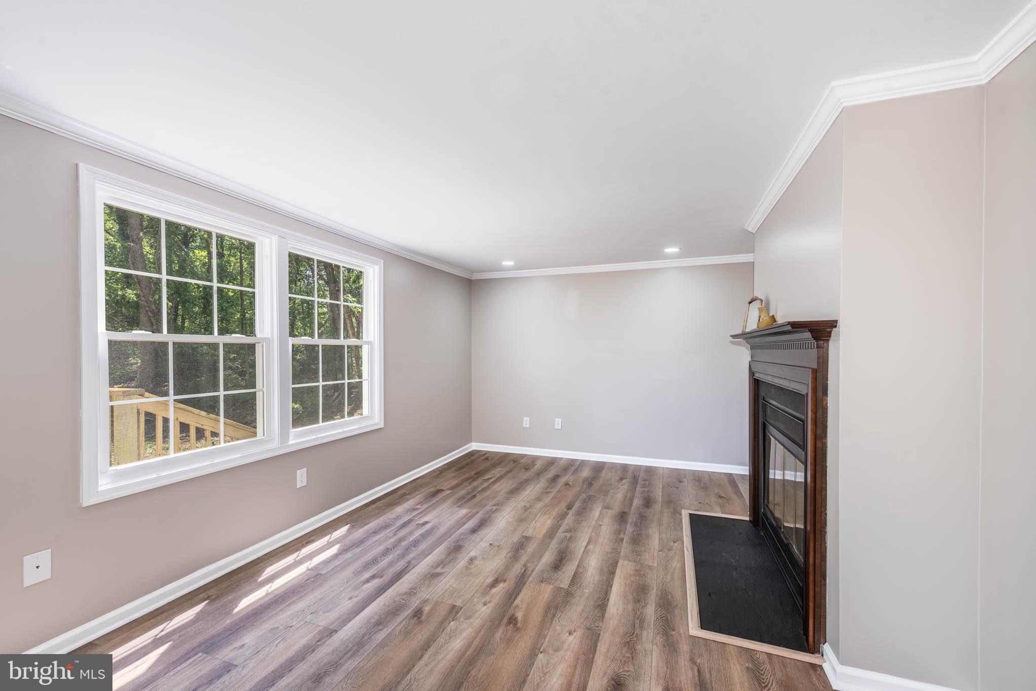 7674 Tuckerman Drive Hanover, MD 21076 - Photo 11 of 45 an empty room with wooden floor and windows