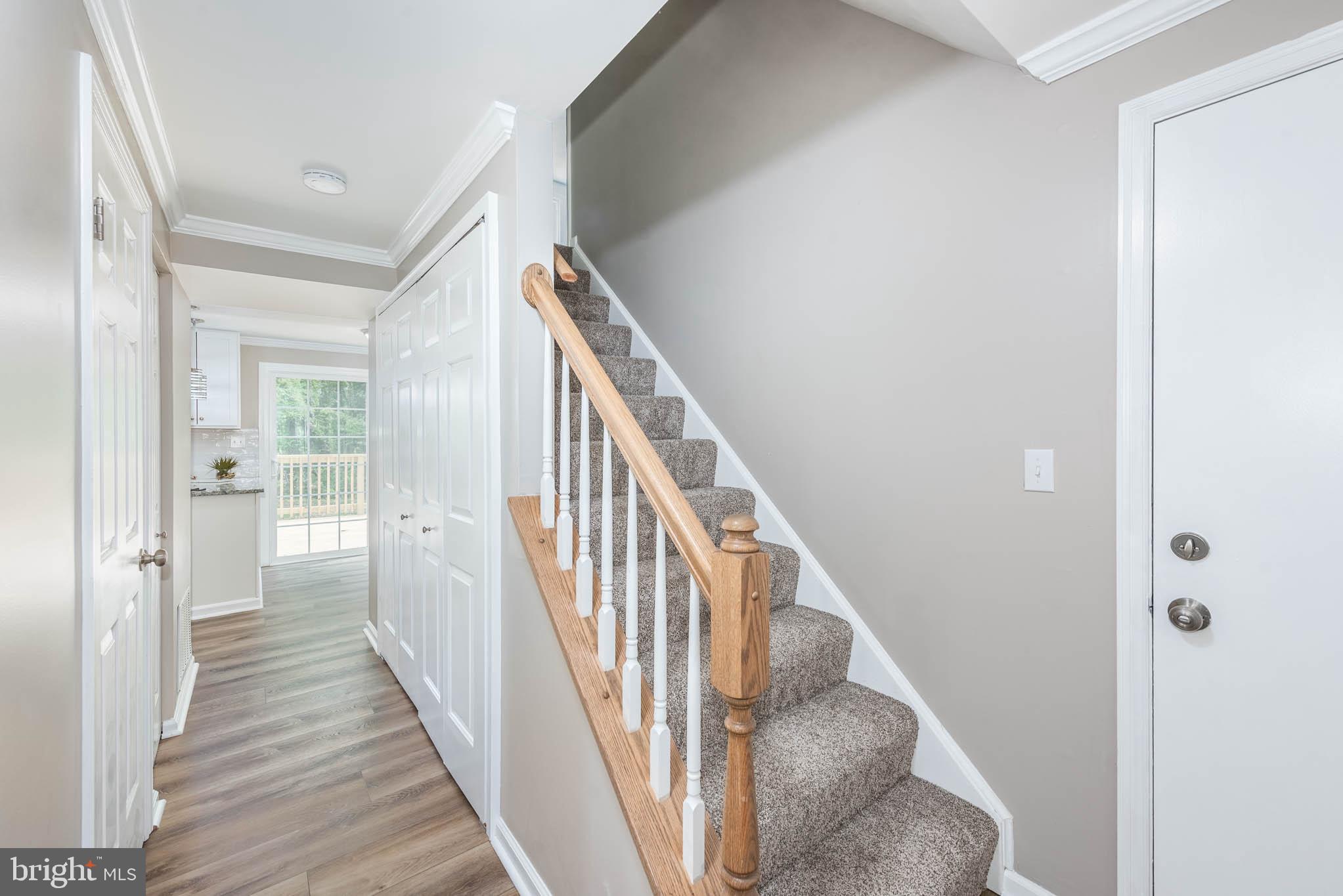 7674 Tuckerman Drive Hanover, MD 21076 - Photo 15 of 45 a view of a hallway with wooden floor and entryway