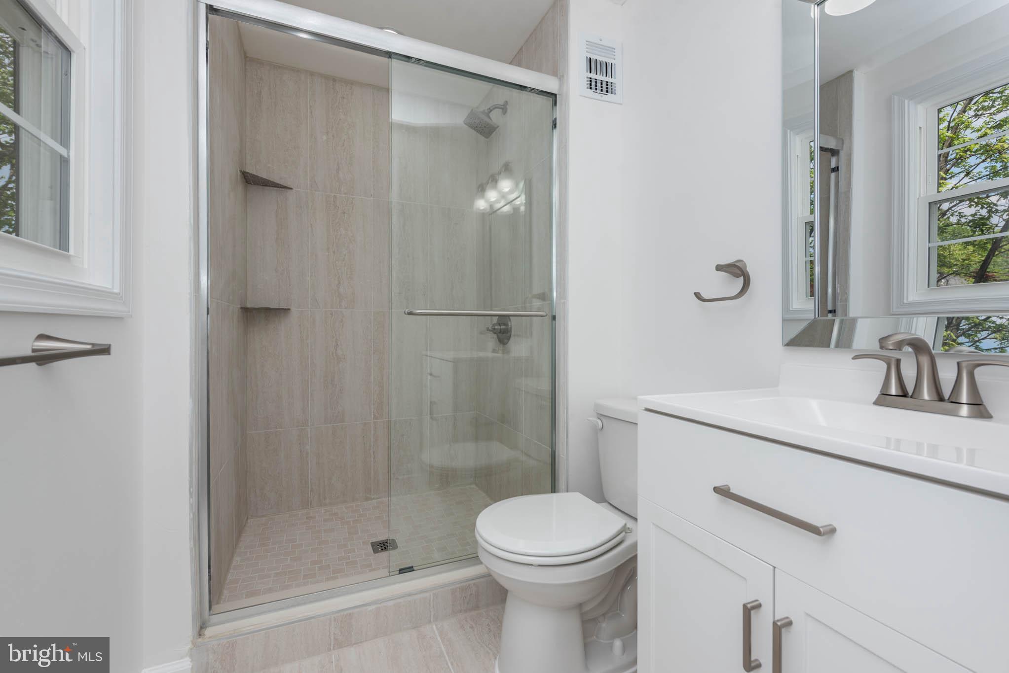 7674 Tuckerman Drive Hanover, MD 21076 - Photo 20 of 45 a bathroom with a sink a toilet and shower