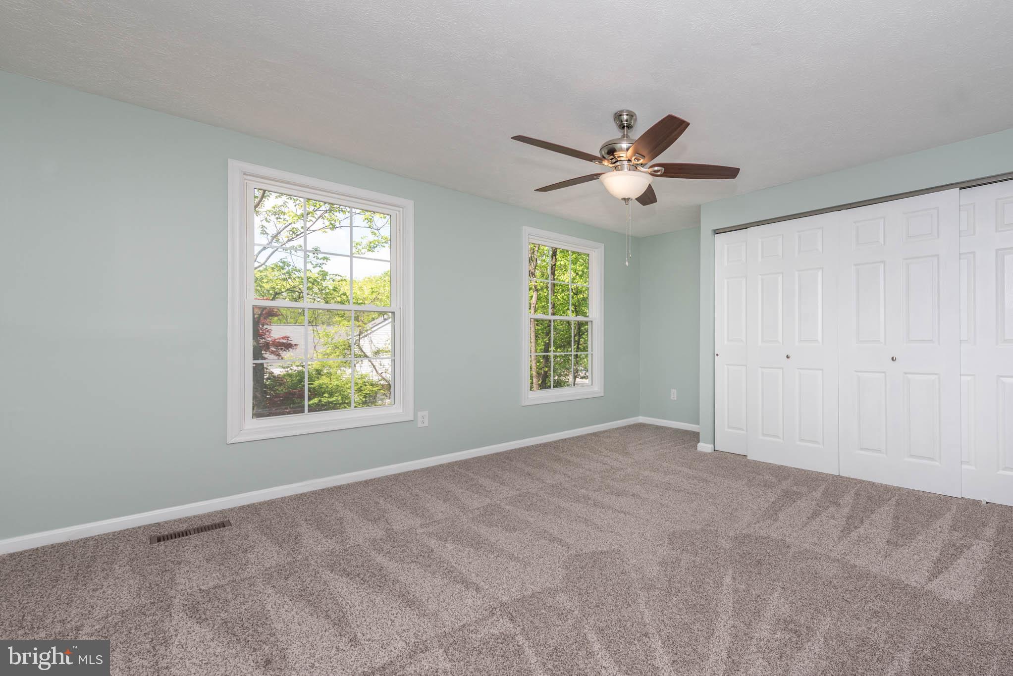 7674 Tuckerman Drive Hanover, MD 21076 - Photo 22 of 45 an empty room with windows and fan