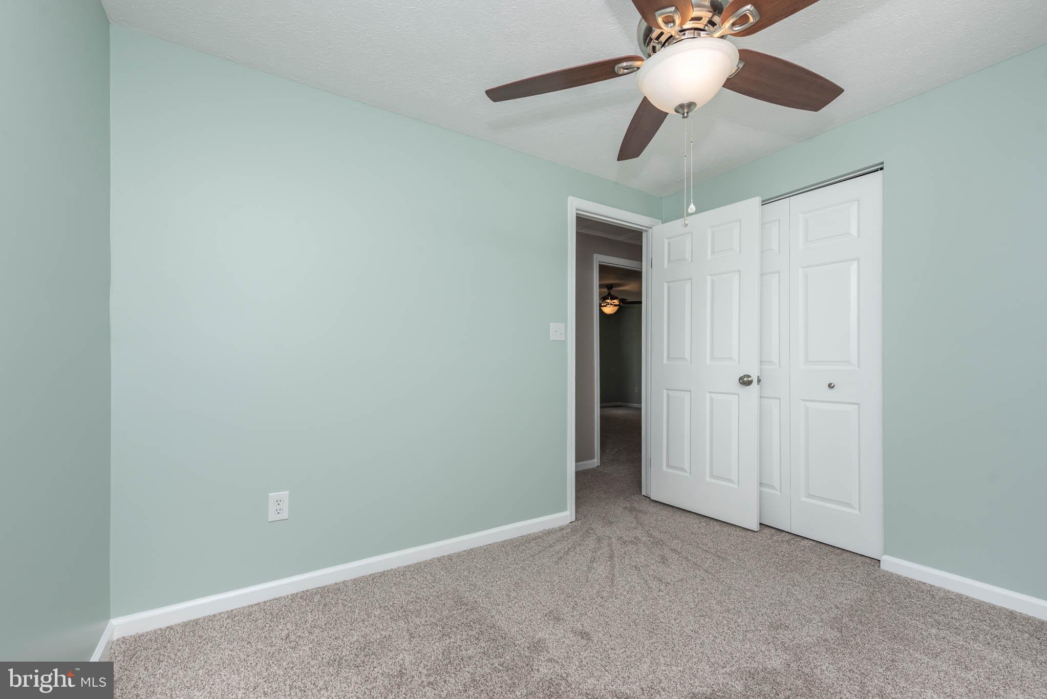 7674 Tuckerman Drive Hanover, MD 21076 - Photo 25 of 45 a view of an empty room and a chandelier fan