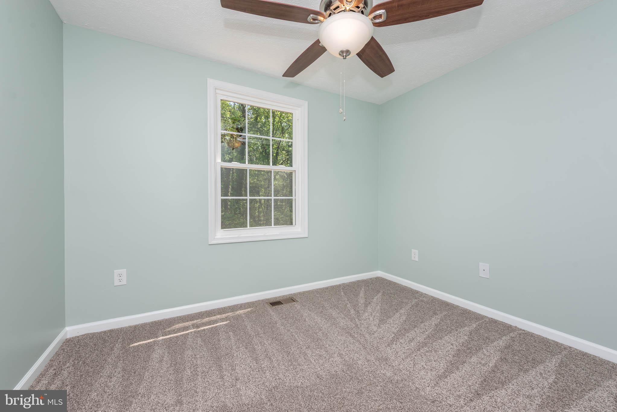 7674 Tuckerman Drive Hanover, MD 21076 - Photo 30 of 45 an empty room with windows and fan