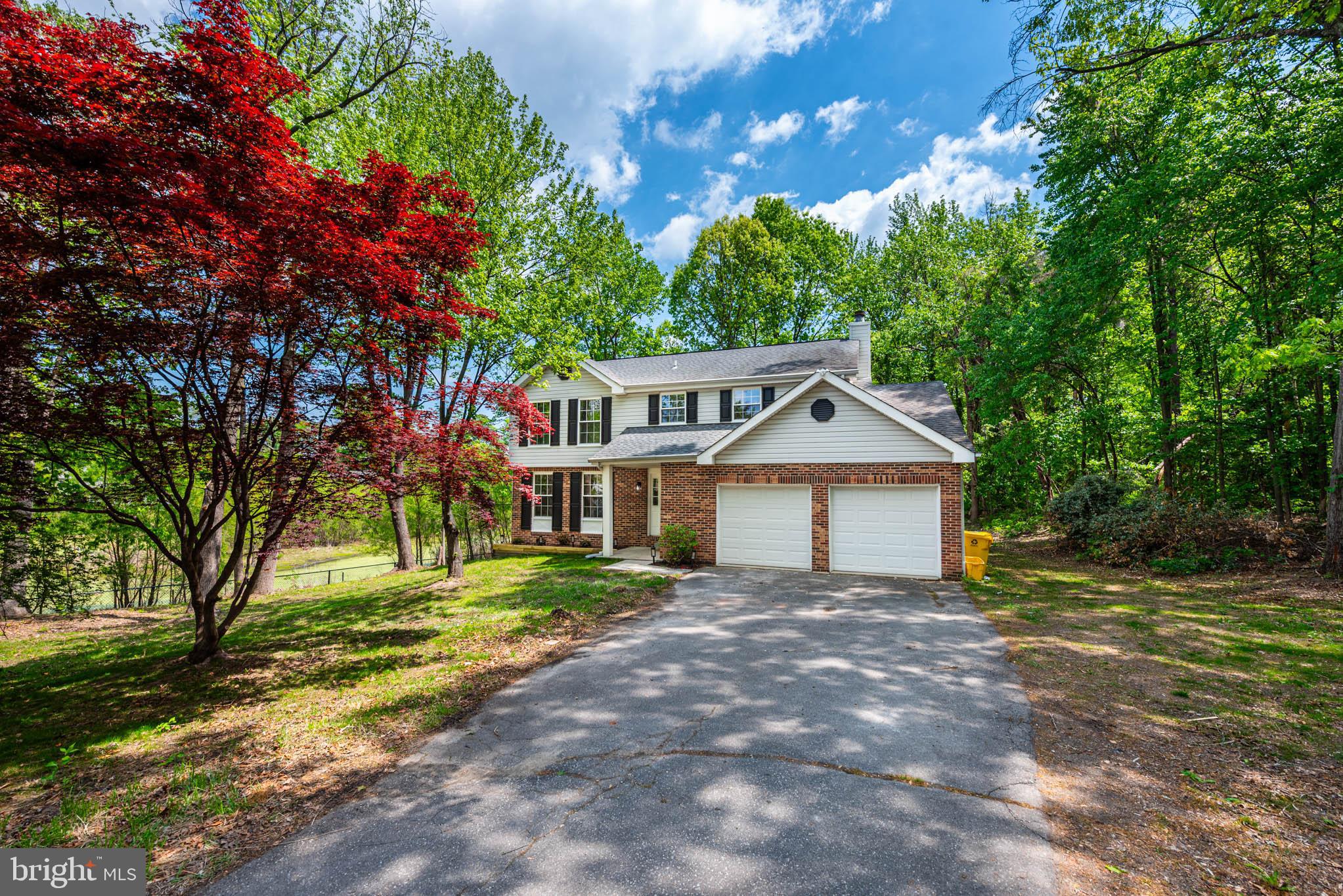 7674 Tuckerman Drive Hanover, MD 21076 - Photo 33 of 45 a front view of a house with a yard