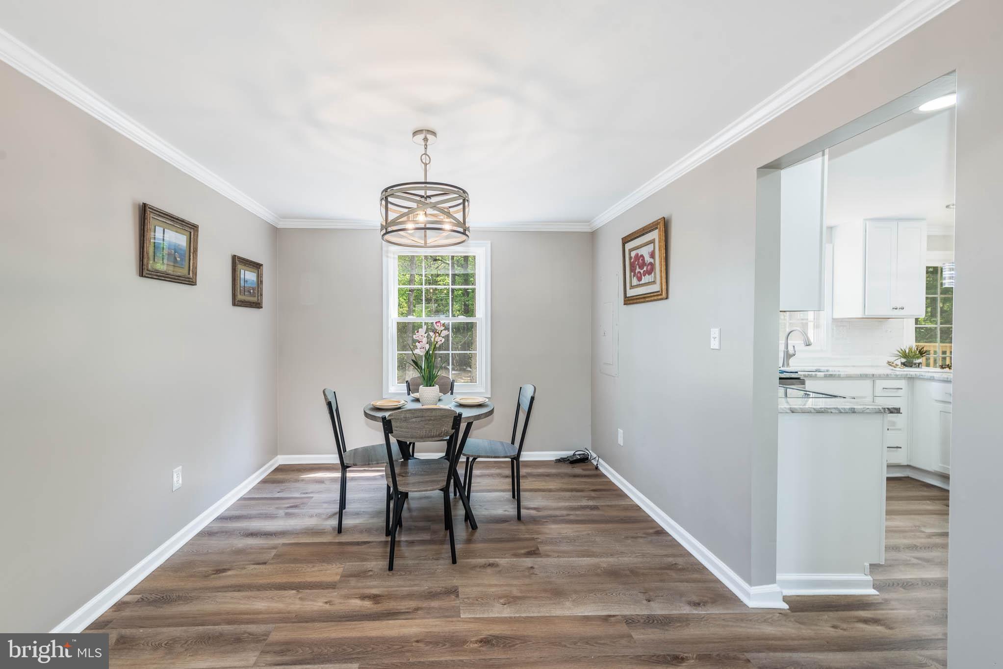 7674 Tuckerman Drive Hanover, MD 21076 - Photo 5 of 45 a view of a dining room with furniture window and wooden floor