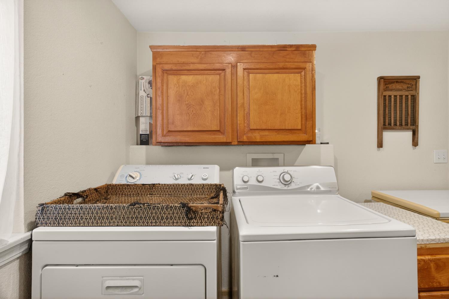 6332 Horseshoe Bar Road Loomis, CA 95650 - Photo 17 of 85 Dedicated laundry area featuring upper wood cabinetry, a white washer, and a white dryer