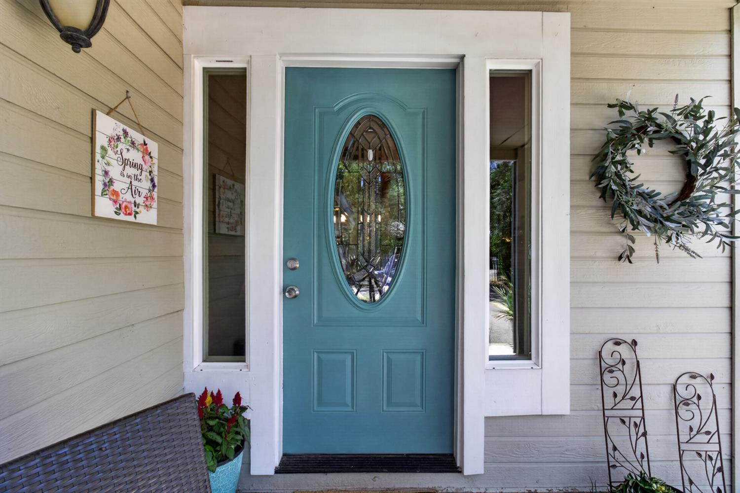 6332 Horseshoe Bar Road Loomis, CA 95650 - Photo 3 of 85 Teal entry door with an oval-shaped decorative glass insert, flanked by clear sidelight windows