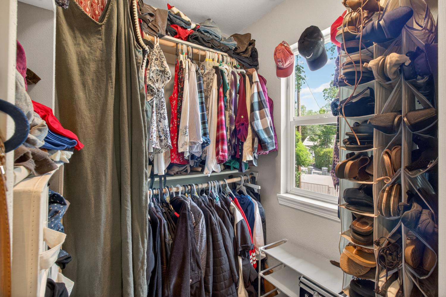 6332 Horseshoe Bar Road Loomis, CA 95650 - Photo 39 of 85 Walk-in closet featuring multiple hanging rods, integrated shelving, and a single pane window
