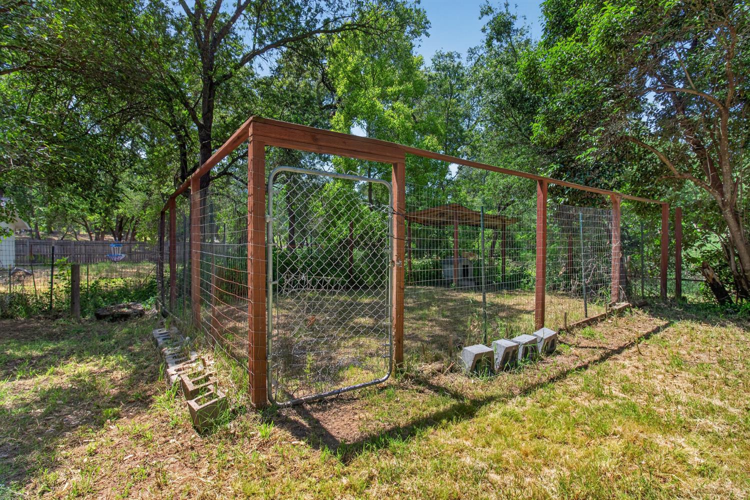 6332 Horseshoe Bar Road Loomis, CA 95650 - Photo 63 of 85 Fenced outdoor enclosure with wood framing and wire mesh, featuring a metal gate entrance