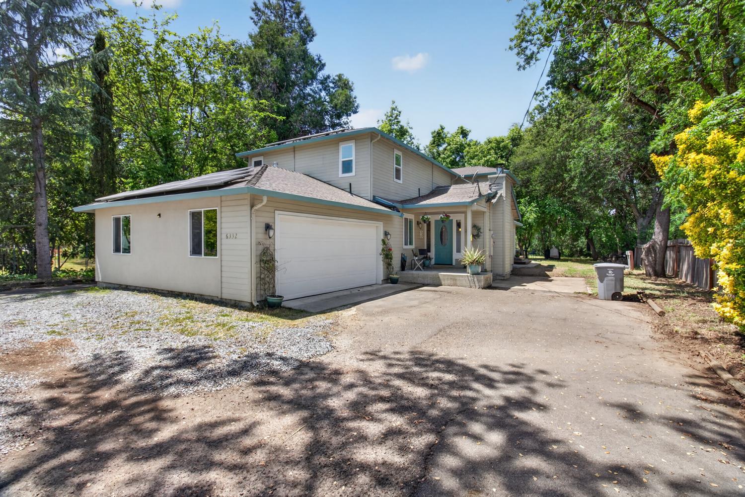 6332 Horseshoe Bar Road Loomis, CA 95650 - Photo 69 of 85 Two-story residence featuring a front entry with a pale blue door, an attached garage, and a gravel driveway