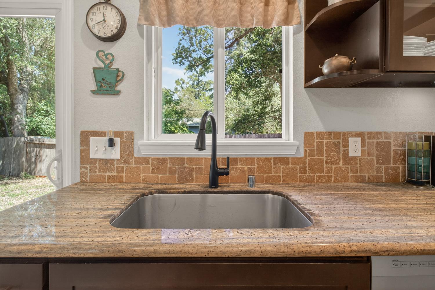 6332 Horseshoe Bar Road Loomis, CA 95650 - Photo 10 of 85 Kitchen sink with a contemporary matte black faucet, set within a granite-finish countertop