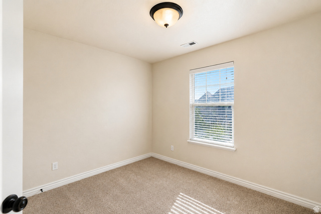 896 Cres Drive South Mapleton, UT 84664 - Photo 22 of 32 Light-filled room featuring neutral wall tones and a window with mountain scenery