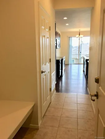 a large kitchen with stainless steel appliances a large counter top a sink a stove and a wooden floors