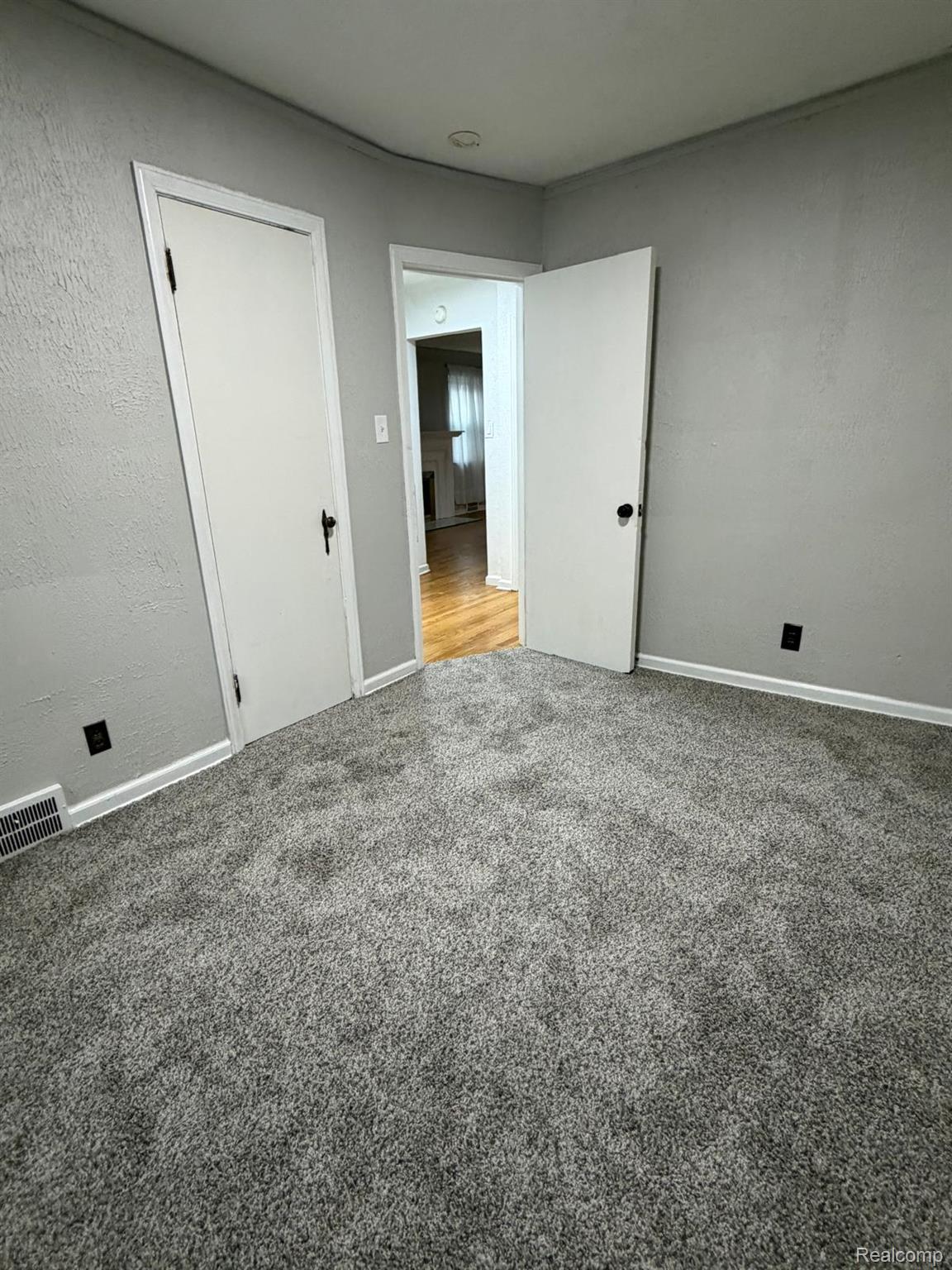 10441 Roxbury Street Detroit, MI 48224 - Photo 12 of 22 Plush gray carpeting with light gray walls and white trim