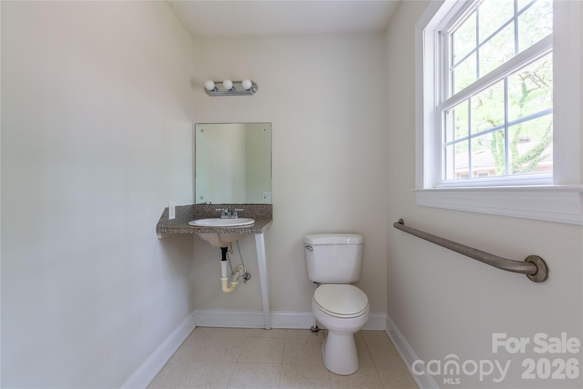 1224 Loop Road Hookerton, NC 28538 - Photo 25 of 47 a bathroom with a toilet sink and mirror