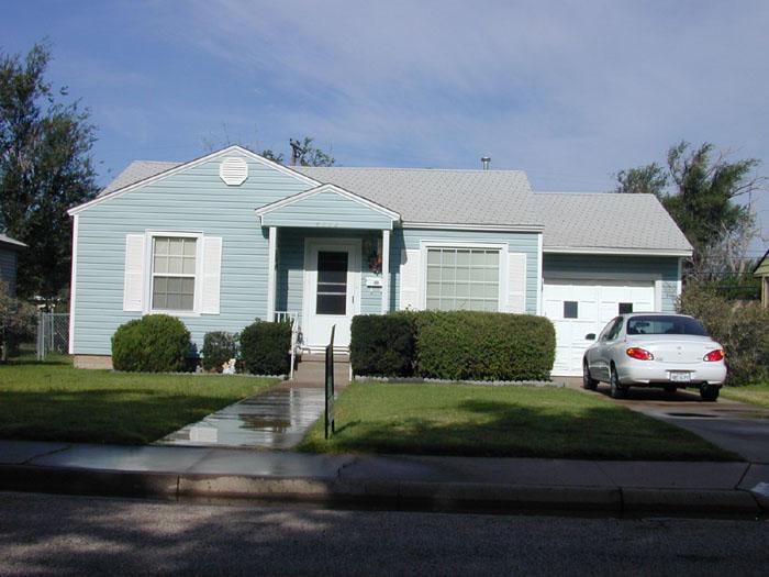 4112 South Travis Street Amarillo, TX 79110 - Photo 1 of 5 a front view of a house with a garden and yard