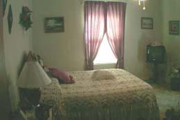 4112 South Travis Street Amarillo, TX 79110 - Photo 2 of 5 a bedroom with a bed and a window