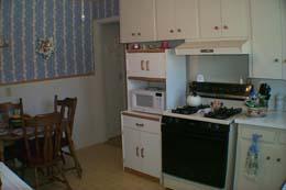 4112 South Travis Street Amarillo, TX 79110 - Photo 4 of 5 a kitchen with stainless steel appliances a stove a sink and white cabinets