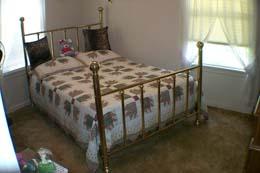 4112 South Travis Street Amarillo, TX 79110 - Photo 5 of 5 a bed sitting in a bedroom next to a window