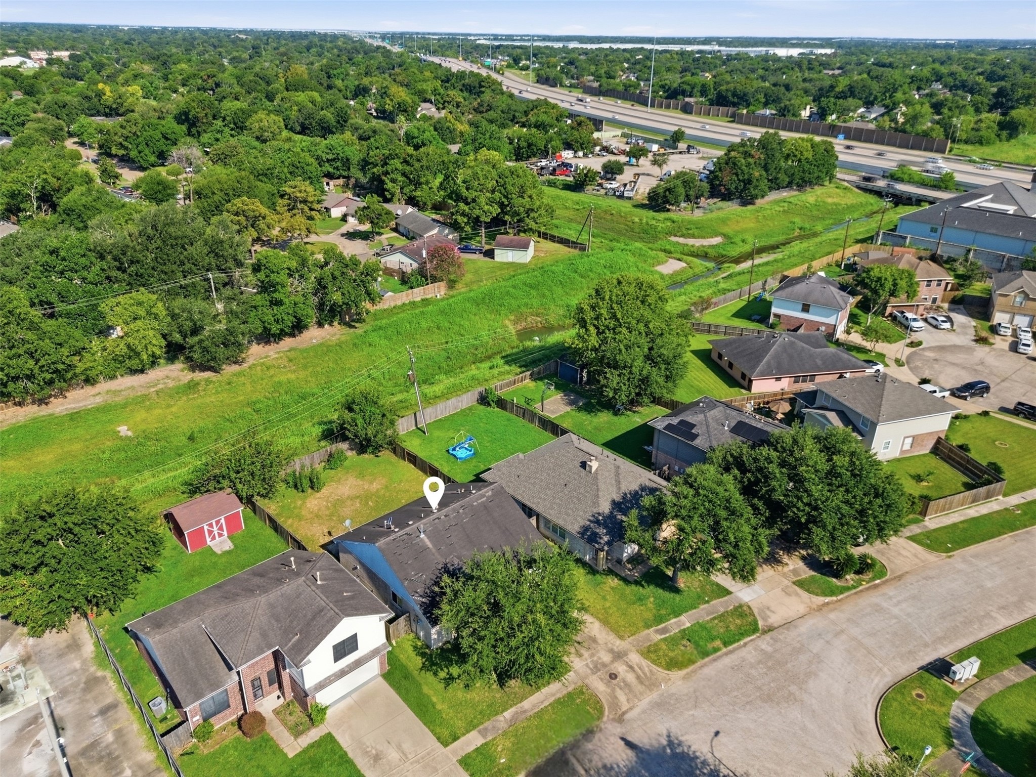 15738 Boonridge Road Houston, TX 77053 - Photo 30 of 31 Charming suburban home with a spacious backyard, backing onto lush green space for added privacy. Located in a peaceful neighborhood with easy access to major highways.