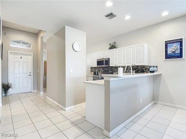 a kitchen with stainless steel appliances a refrigerator sink and cabinets