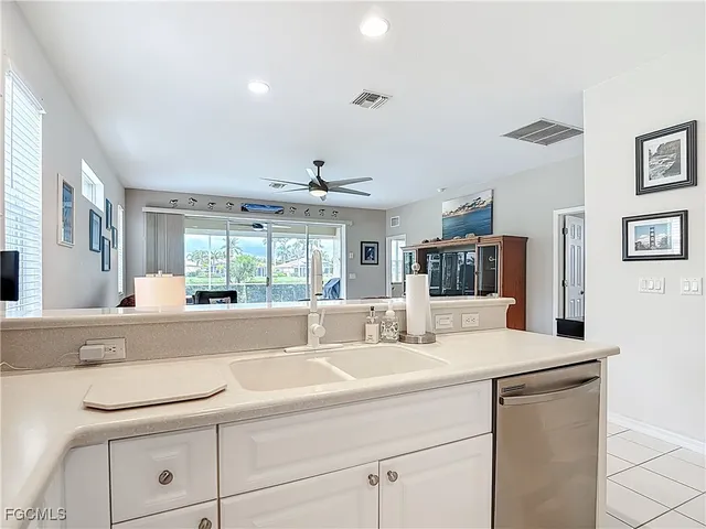 a room with a sink and large mirror