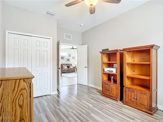 a view of room with window and wooden floor