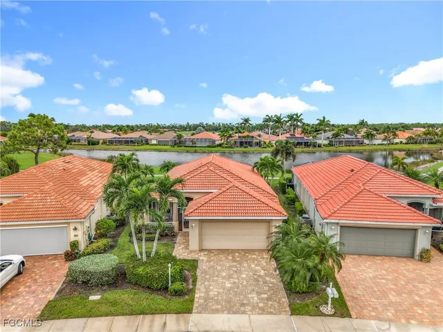 an aerial view of house with yard and ocean view