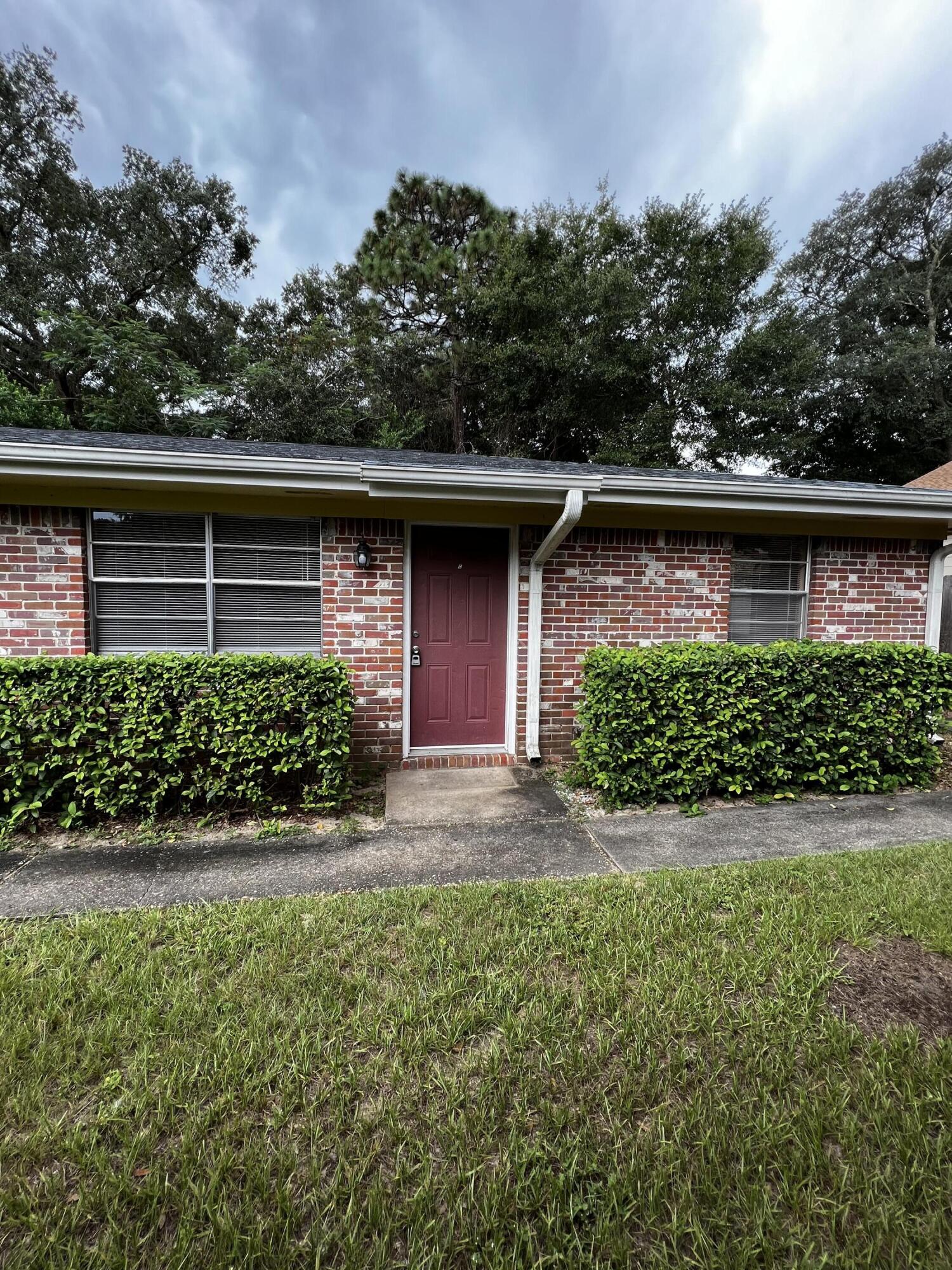 537 Hickory Avenue, Unit B Niceville, FL 32578 - Photo 1 of 19 a front view of a house with a yard