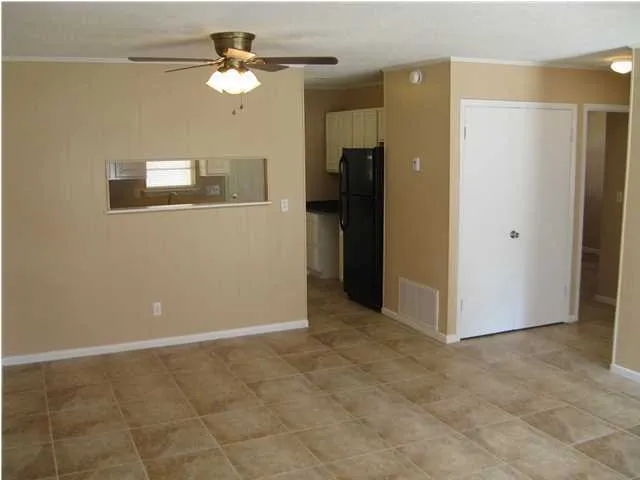 a view of a room with a ceiling fan
