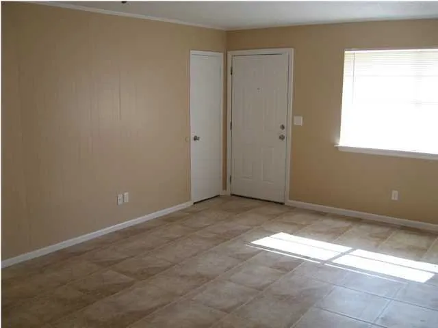 a view of an empty room and a window