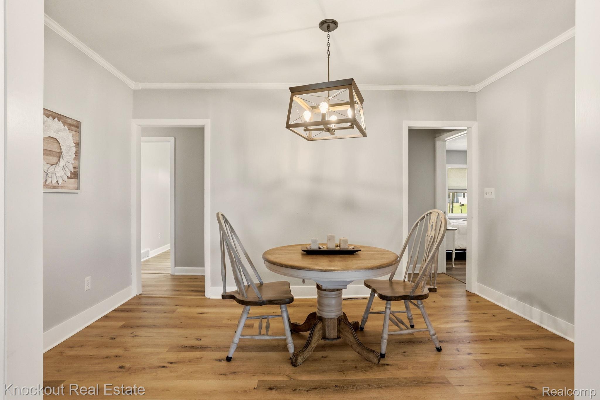 9941 Lange Road Birch Run, MI 48415 - Photo 17 of 42 Dining area featuring wood-finish flooring, light gray wall paint, and white trim