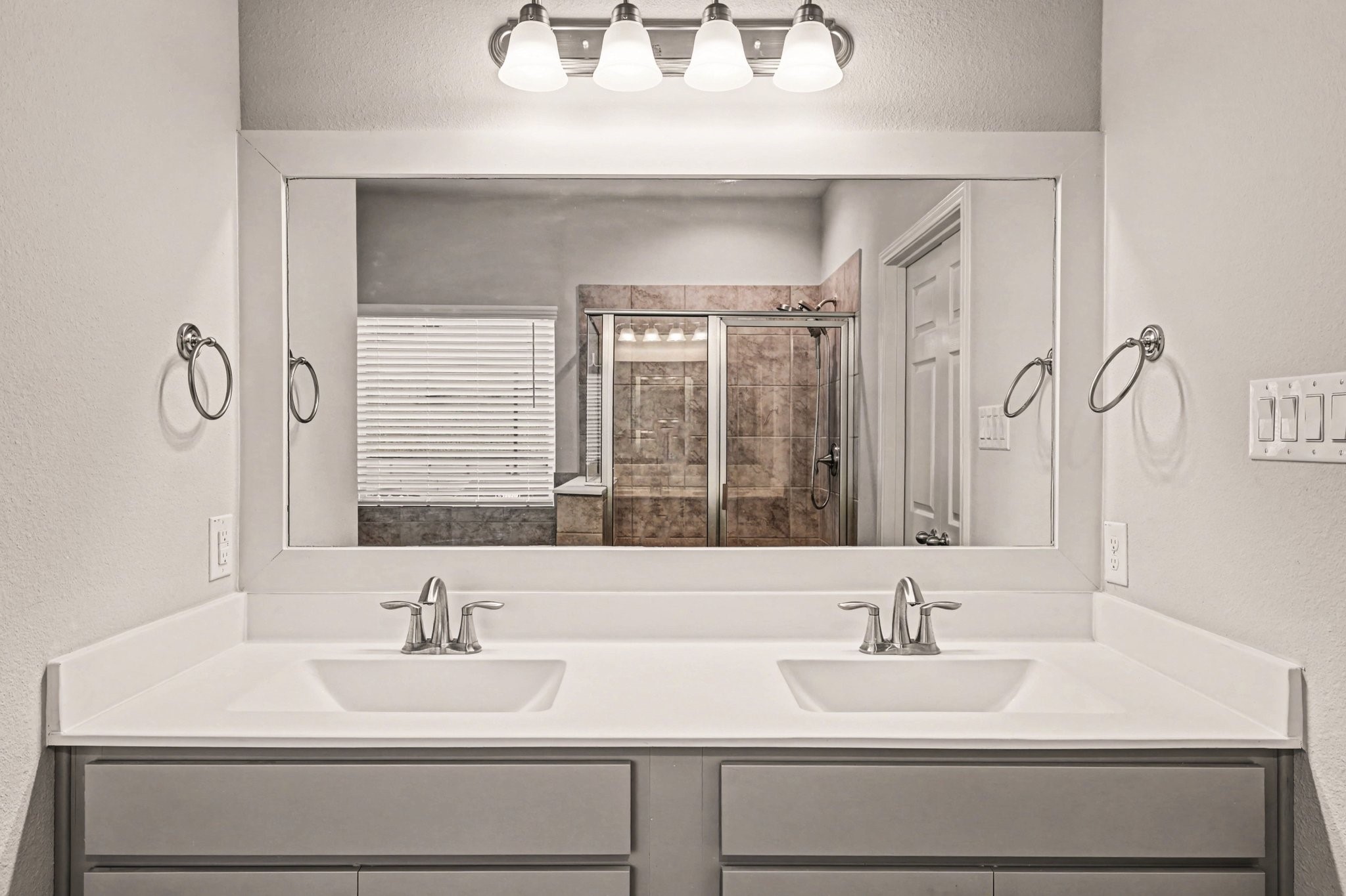 320 Red Maple Lane Conroe, TX 77304 - Photo 13 of 24 Sleek double sink vanity with on-trend gray finishes and brushed nickel hardware.