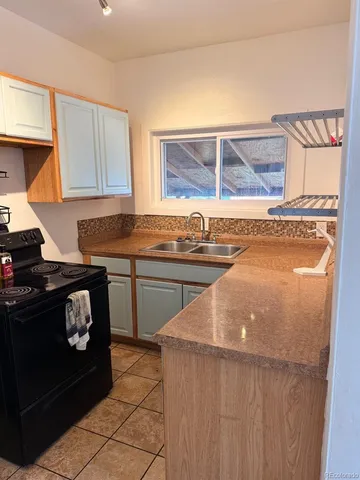 a kitchen with a stove a sink and a microwave