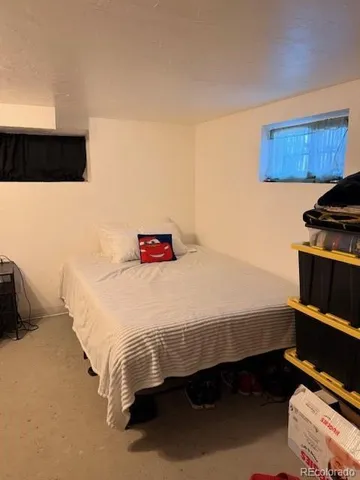 a bedroom with a bed and dresser