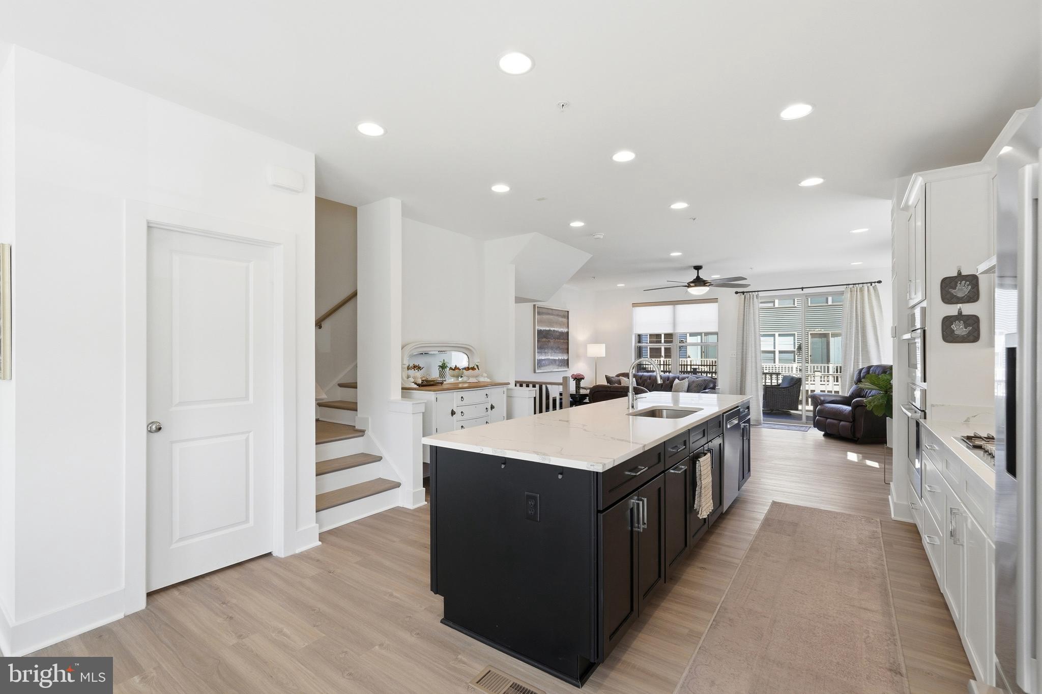 3311 Streamlet Lane Laurel, MD 20724 - Photo 13 of 46 a large kitchen with a large counter top a sink stainless steel appliances and cabinets