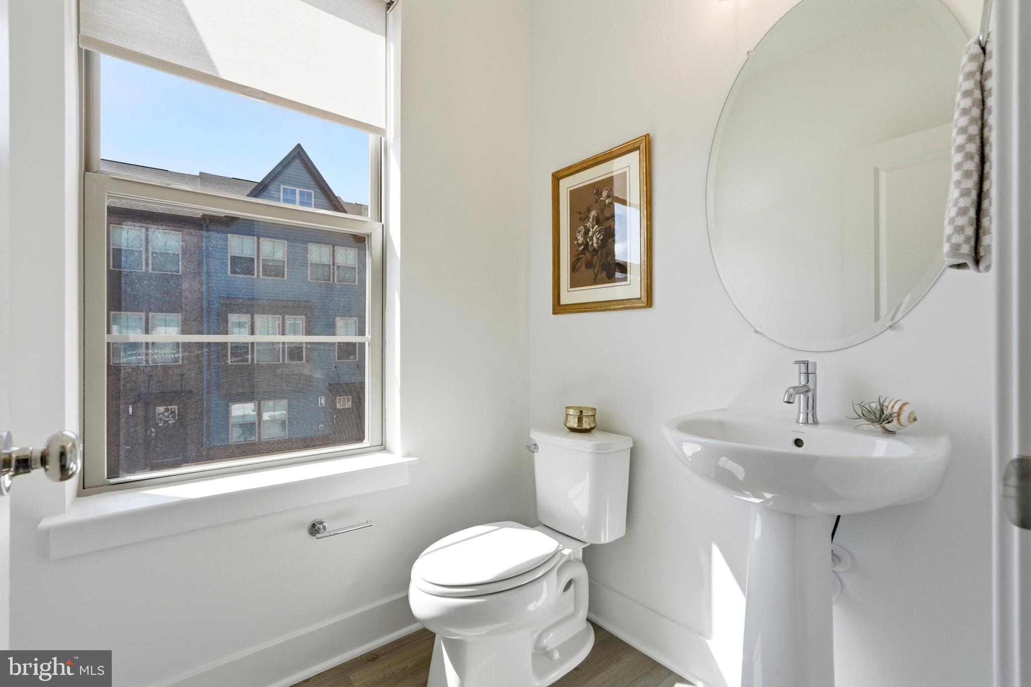 3311 Streamlet Lane Laurel, MD 20724 - Photo 21 of 46 a bathroom with a toilet sink and mirror