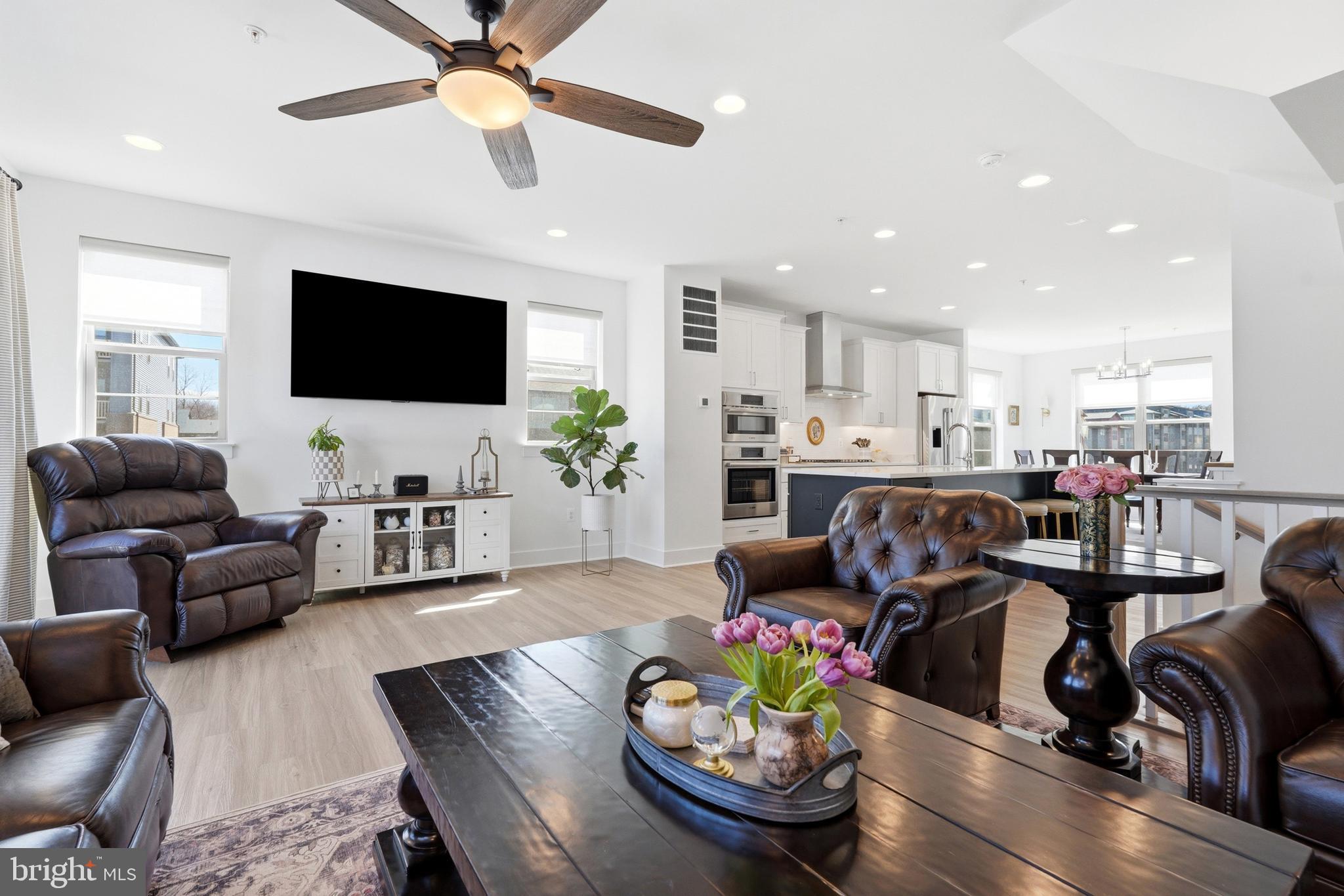 3311 Streamlet Lane Laurel, MD 20724 - Photo 22 of 46 a living room with furniture kitchen view and a flat screen tv