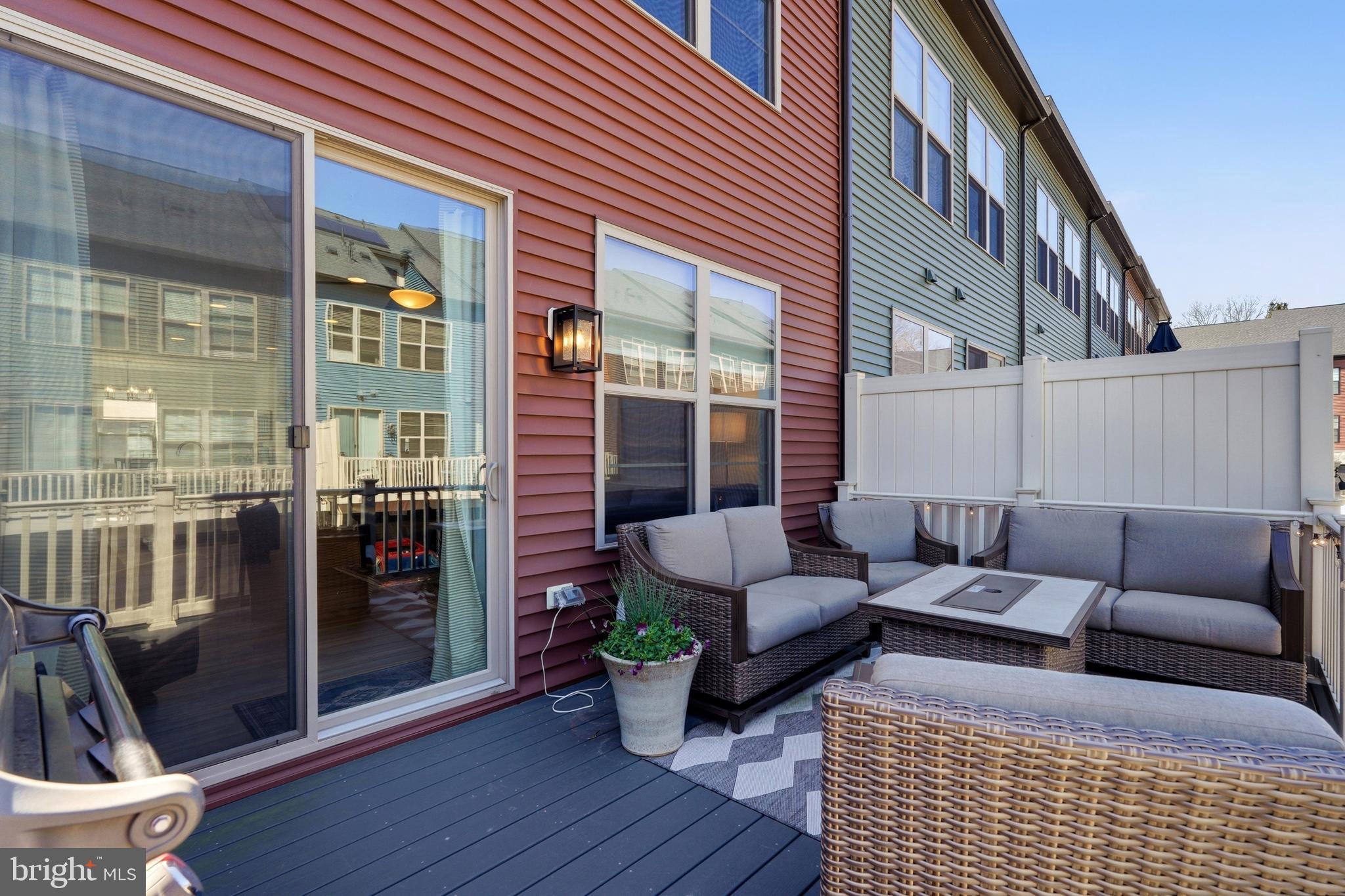 3311 Streamlet Lane Laurel, MD 20724 - Photo 25 of 46 a view of a patio with couches table and chairs and wooden floor