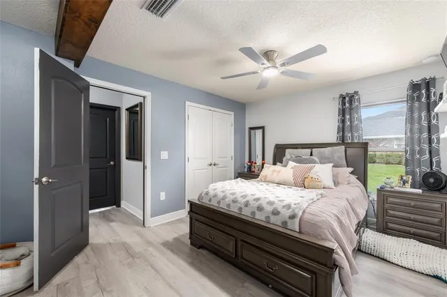 a bedroom with bed and a chandelier