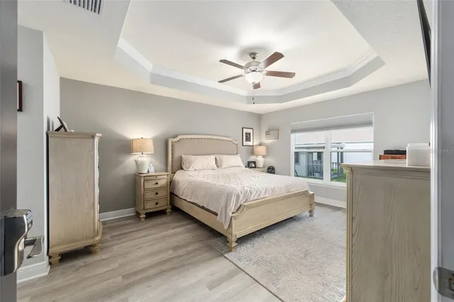 a bedroom with a bed and a chandelier