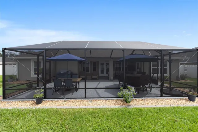 a view of a house with yard and sitting area