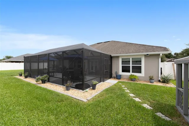 a view of a house with a yard and sitting area