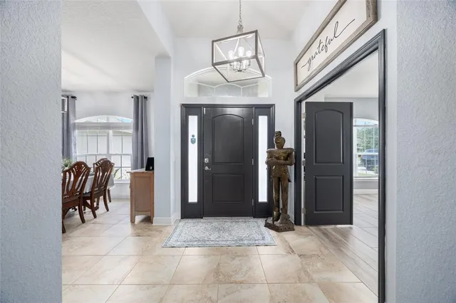 a view of a hallway with wooden furniture and windows
