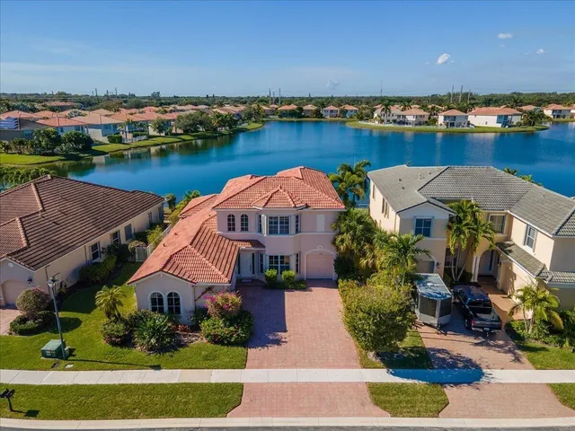 an aerial view of a house with a lake view