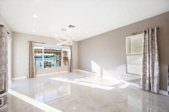 a view of an empty room with a fireplace and a large window