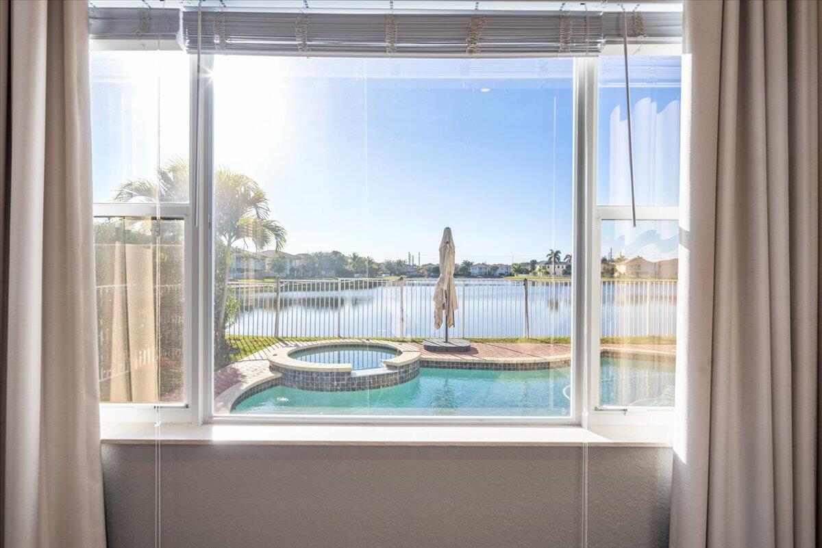 1238 Bay View Way Wellington, FL 33414 - Photo 18 of 39 a view of a balcony with lake view and a floor to ceiling window