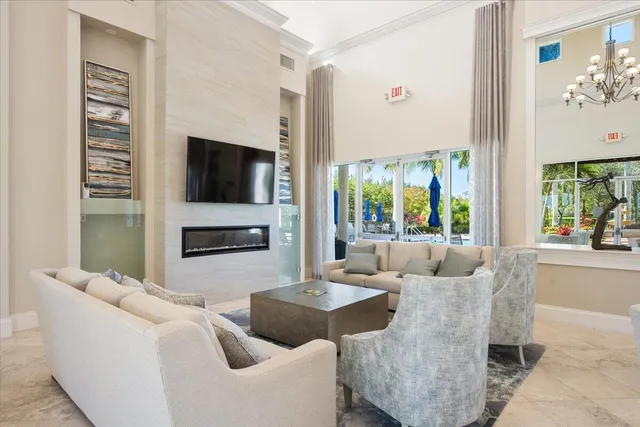 a living room with furniture a flat screen tv and a large window