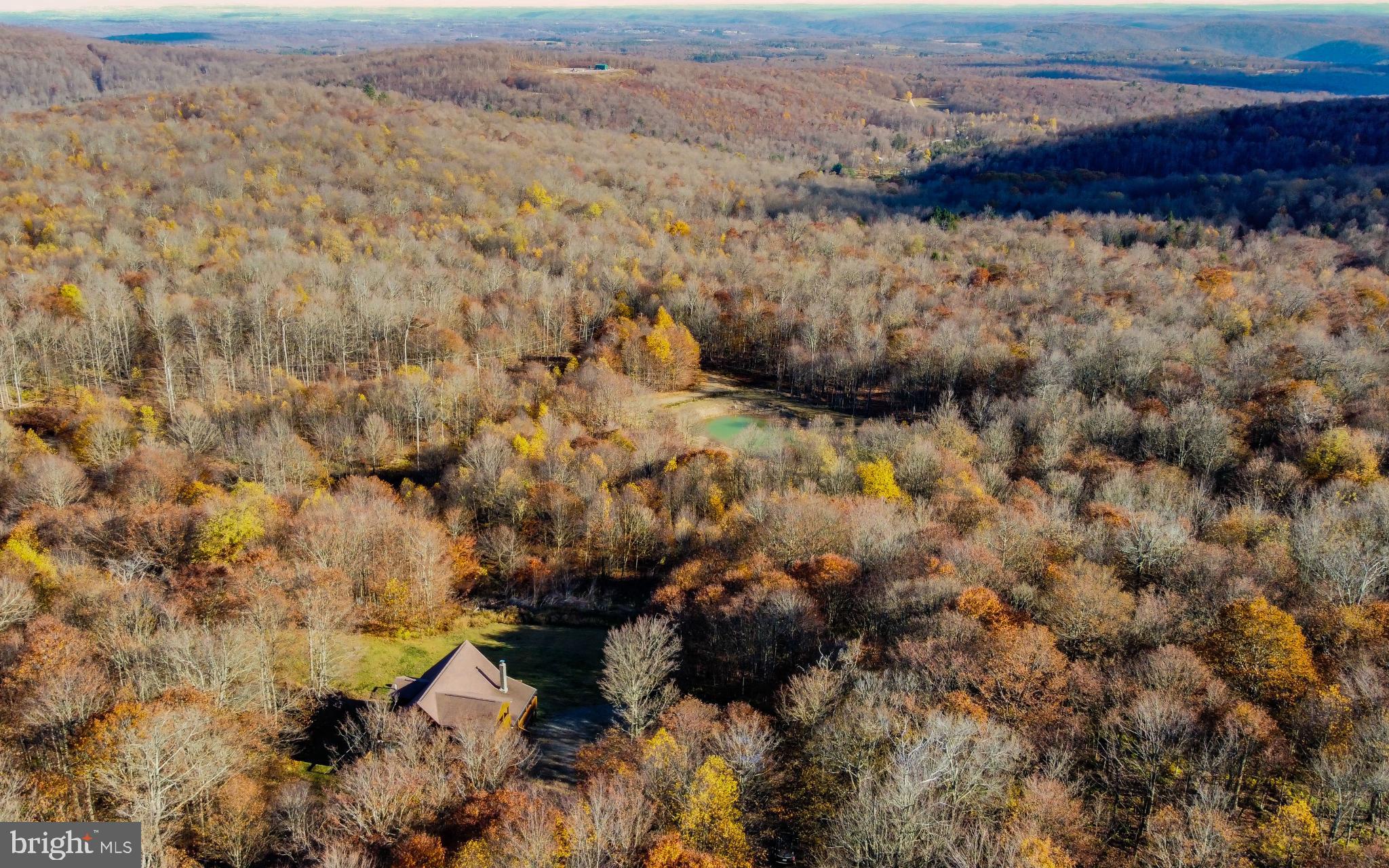 115 Glory Rdg Road Shunk, PA 17768 - Photo 35 of 35 Serene autumn landscape with a cozy retreat.